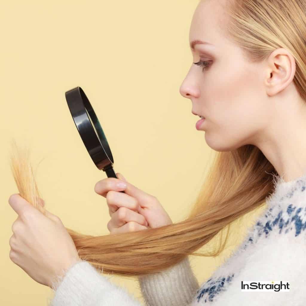 lady examining her damaged hair